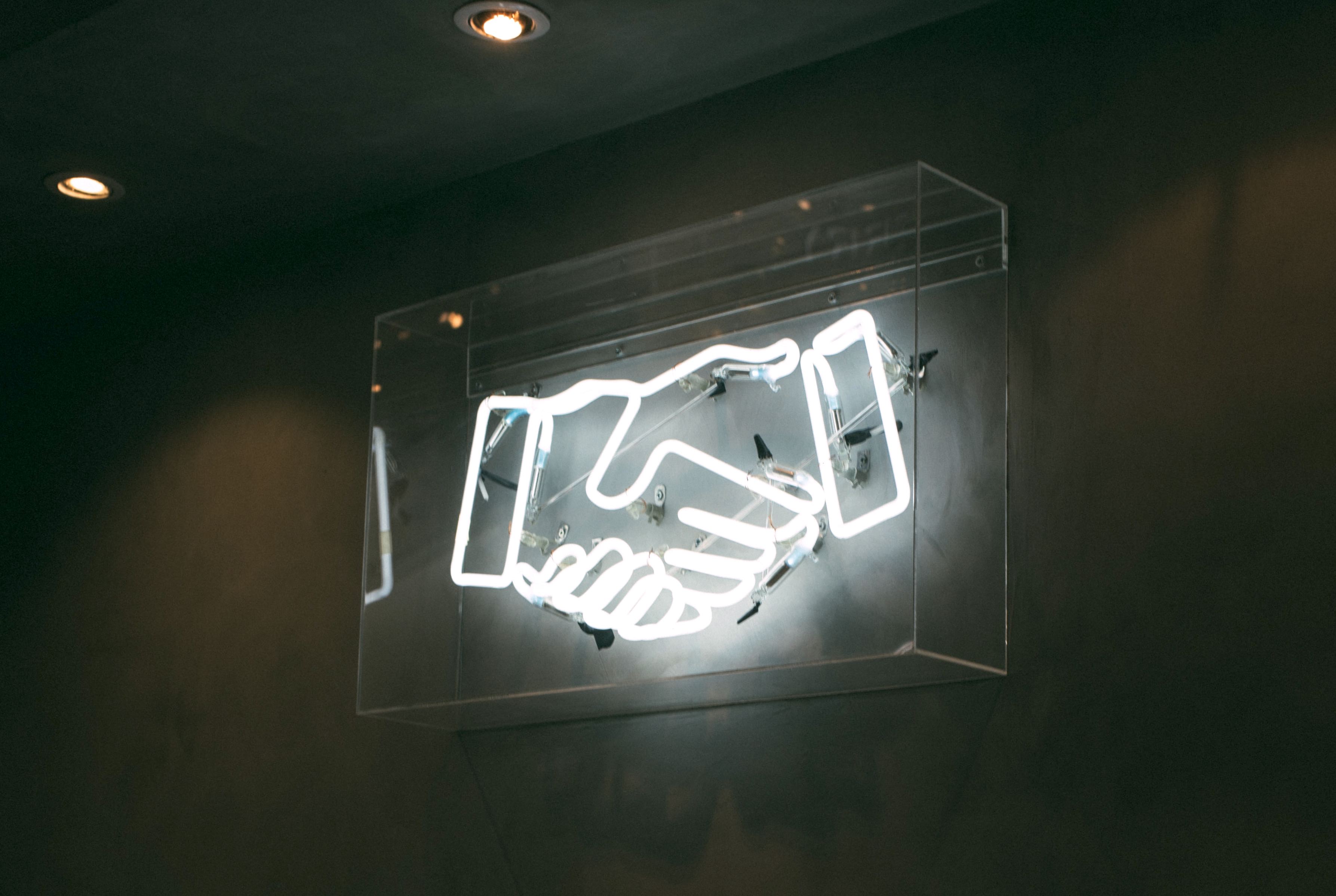images/shaking-hands-neon-sign.jpg